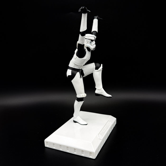 Side view of an officially licensed Stormtrooper Crane Kick figurine balancing on one leg in a martial arts pose on a display base.