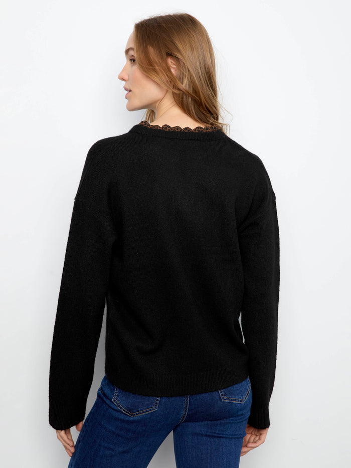 Trendy black sweater showcasing leopard print trim on the neckline for an edgy touch by Charlie B.