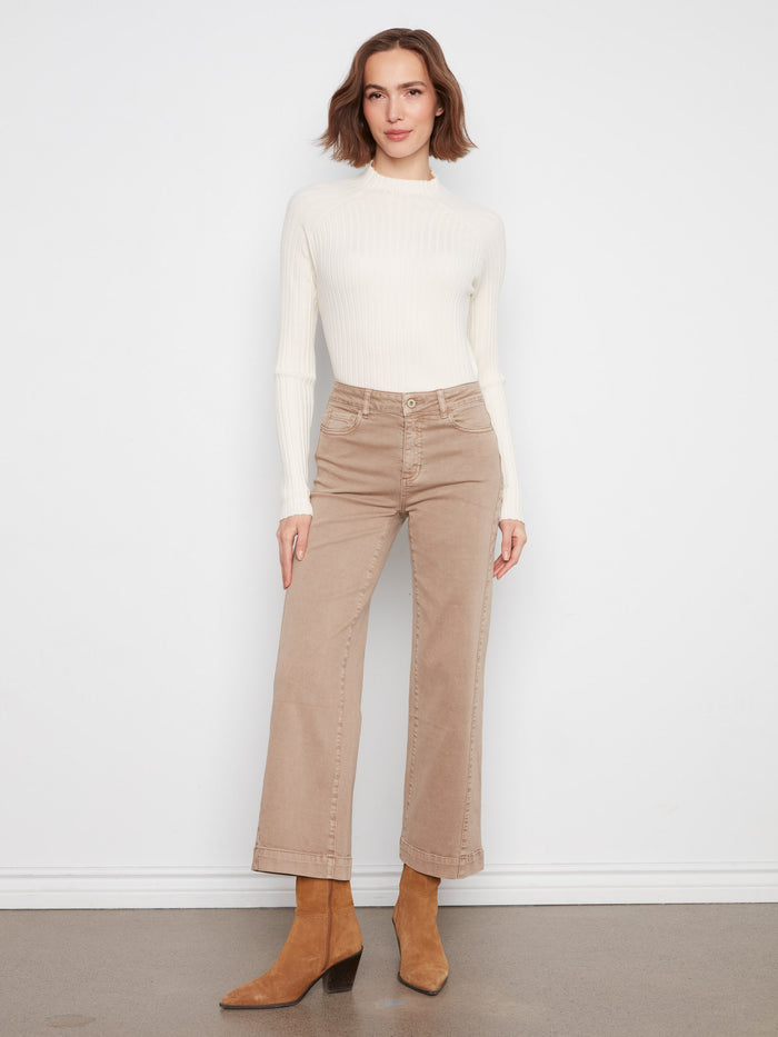 Ankle-length latte pants crafted from stretch twill fabric, matched with a white long-sleeve top and brown boots by Charlie B.